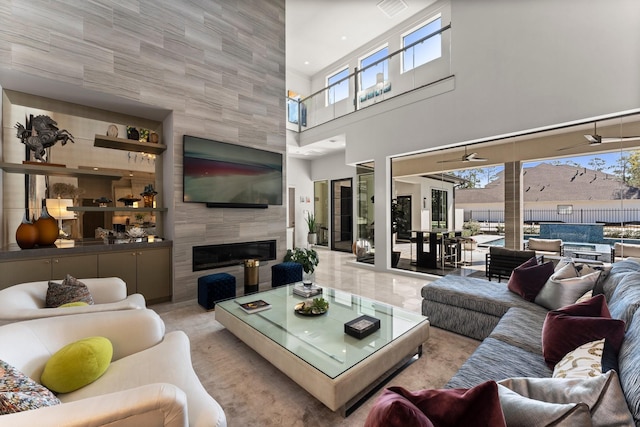 living room featuring a tiled fireplace