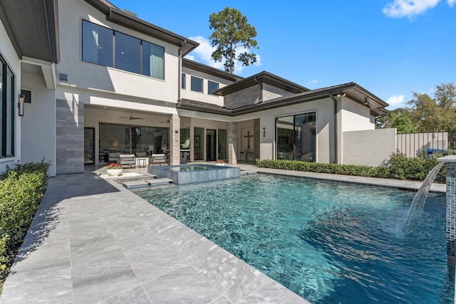 view of pool featuring a pool with connected hot tub, an outdoor living space, fence, ceiling fan, and a patio area