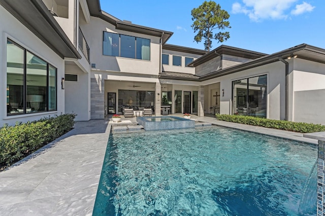 view of swimming pool with a ceiling fan, a pool with connected hot tub, outdoor lounge area, and a patio area