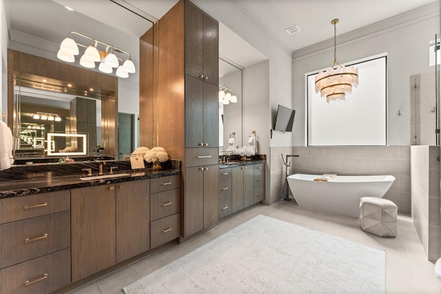 full bathroom with visible vents, crown molding, a freestanding bath, tile patterned floors, and vanity