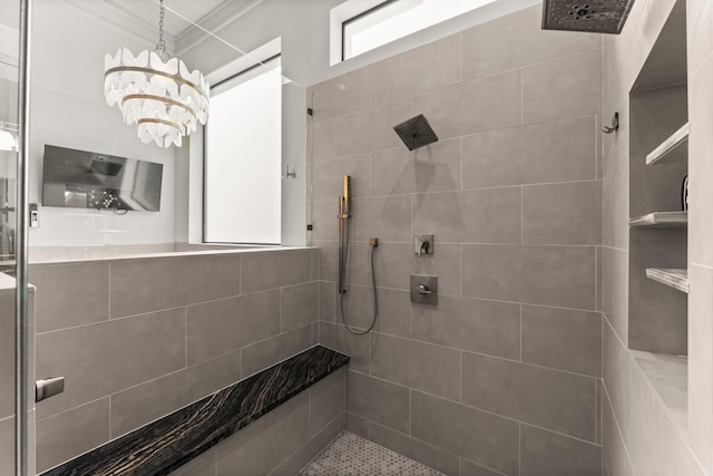 full bath with a chandelier and tiled shower