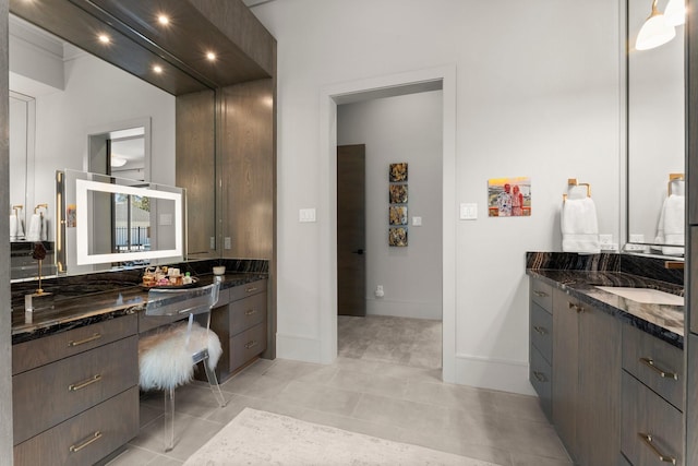 bathroom featuring tile patterned floors, baseboards, and vanity