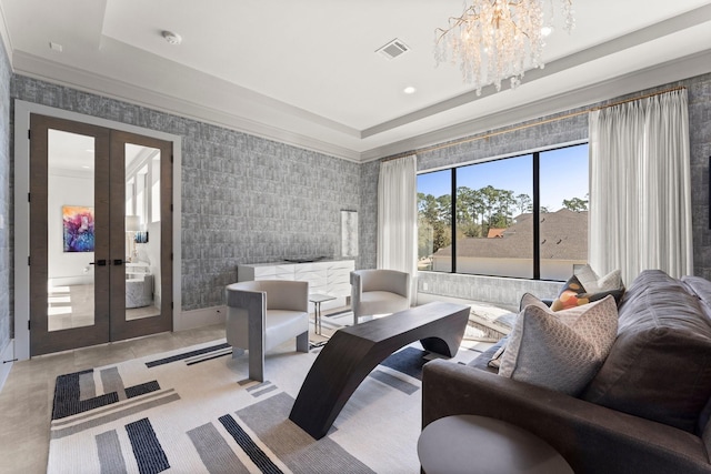 living area with a tray ceiling, recessed lighting, french doors, wallpapered walls, and a chandelier