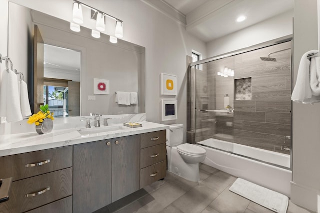 full bath with tile patterned floors, toilet, ornamental molding, enclosed tub / shower combo, and vanity