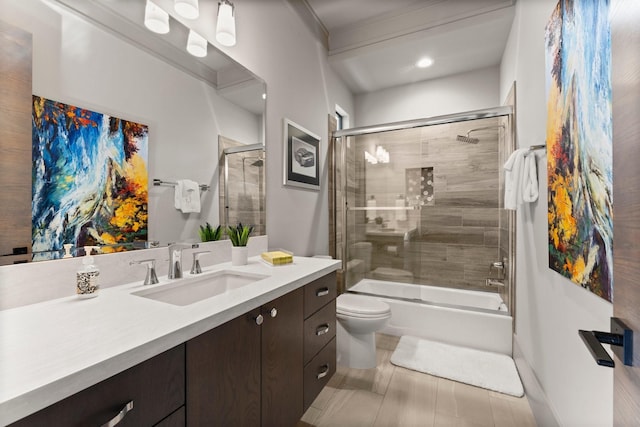 bathroom with enclosed tub / shower combo, toilet, and vanity