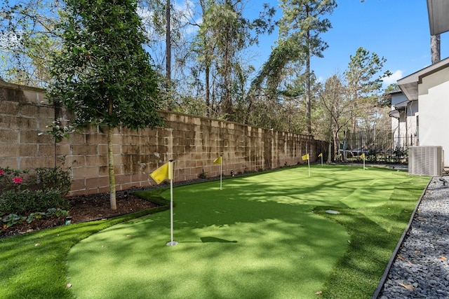 view of yard featuring central air condition unit, a trampoline, and a fenced backyard