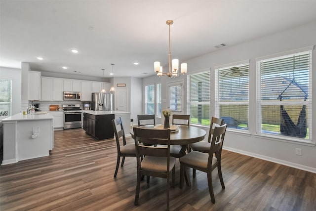 dining room featuring visible vents, dark wood-type flooring, recessed lighting, baseboards, and a chandelier