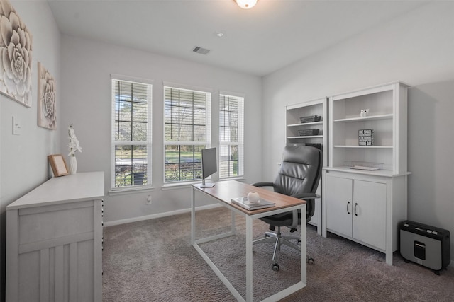 office with visible vents, baseboards, and dark colored carpet