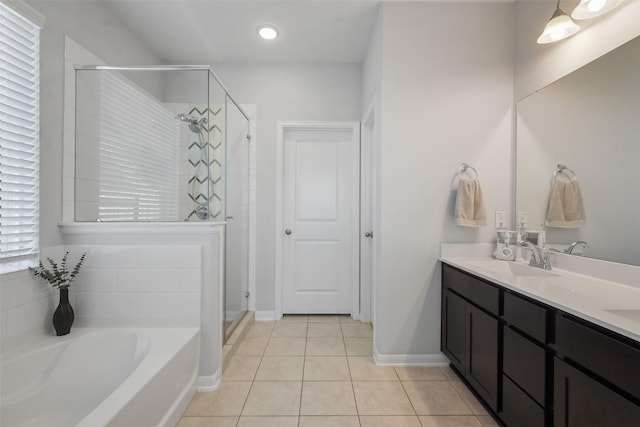 bathroom with a stall shower, a sink, tile patterned flooring, double vanity, and a bath