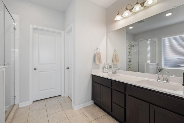 bathroom with tile patterned flooring, a stall shower, double vanity, and a sink