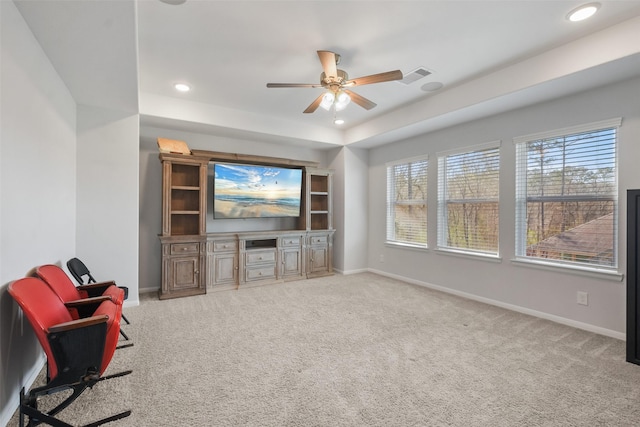 living room with a tray ceiling, visible vents, baseboards, and carpet floors