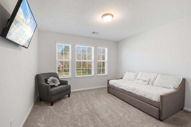 living area featuring visible vents, baseboards, and carpet floors