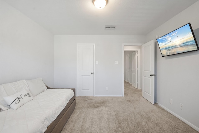 carpeted bedroom with visible vents and baseboards