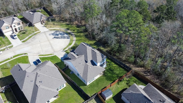 drone / aerial view featuring a view of trees and a residential view