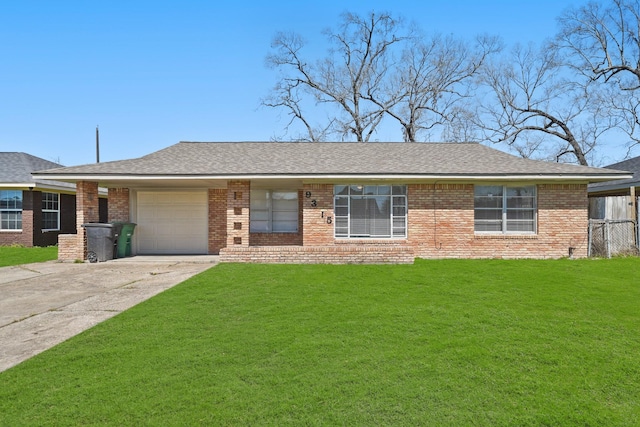 view of front of home featuring driveway, a shingled roof, a front lawn, a garage, and brick siding