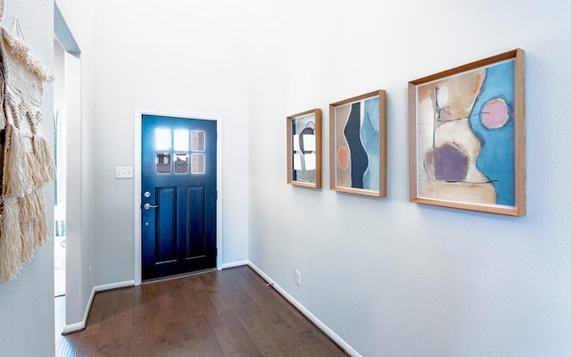 entryway featuring dark wood-type flooring and baseboards