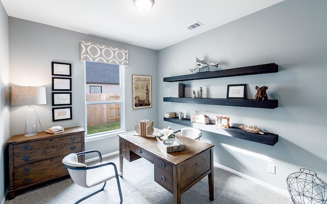 carpeted home office featuring visible vents and baseboards