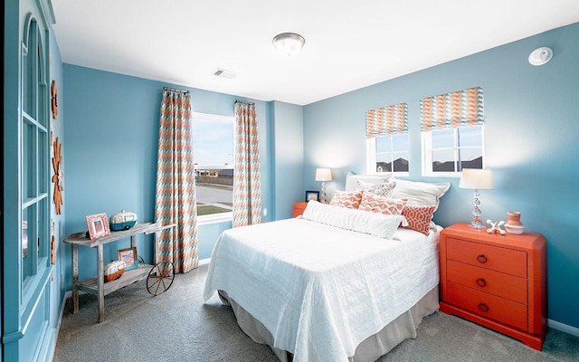 bedroom featuring visible vents, carpet floors, and baseboards