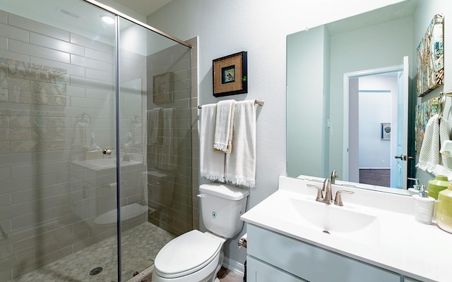 full bathroom featuring visible vents, a stall shower, toilet, and vanity