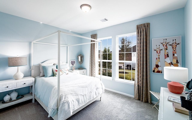 bedroom with visible vents, carpet floors, and baseboards