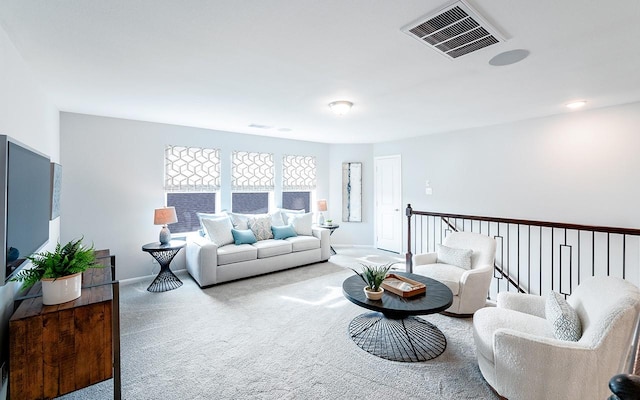 living room with visible vents, baseboards, and carpet flooring