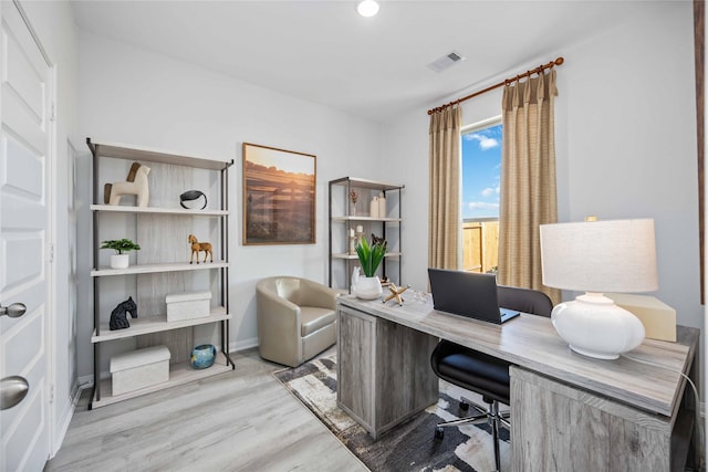 office featuring visible vents, baseboards, and wood finished floors