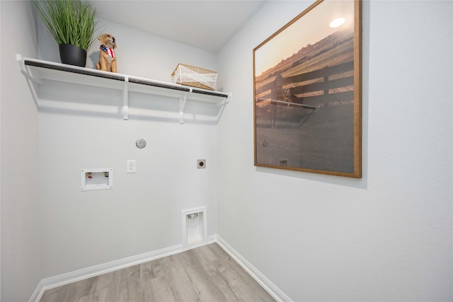 laundry room featuring electric dryer hookup, washer hookup, wood finished floors, baseboards, and laundry area