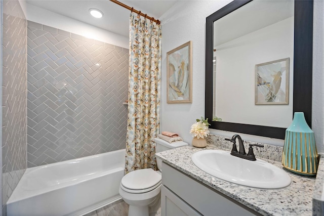 bathroom featuring vanity, toilet, and shower / bath combo with shower curtain