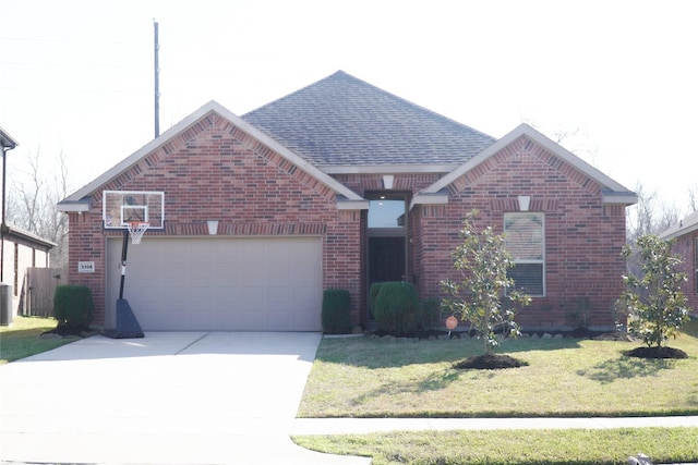 view of front of house with brick siding, an attached garage, a shingled roof, and a front yard