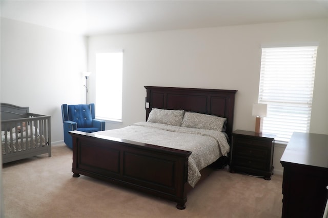 bedroom featuring light colored carpet