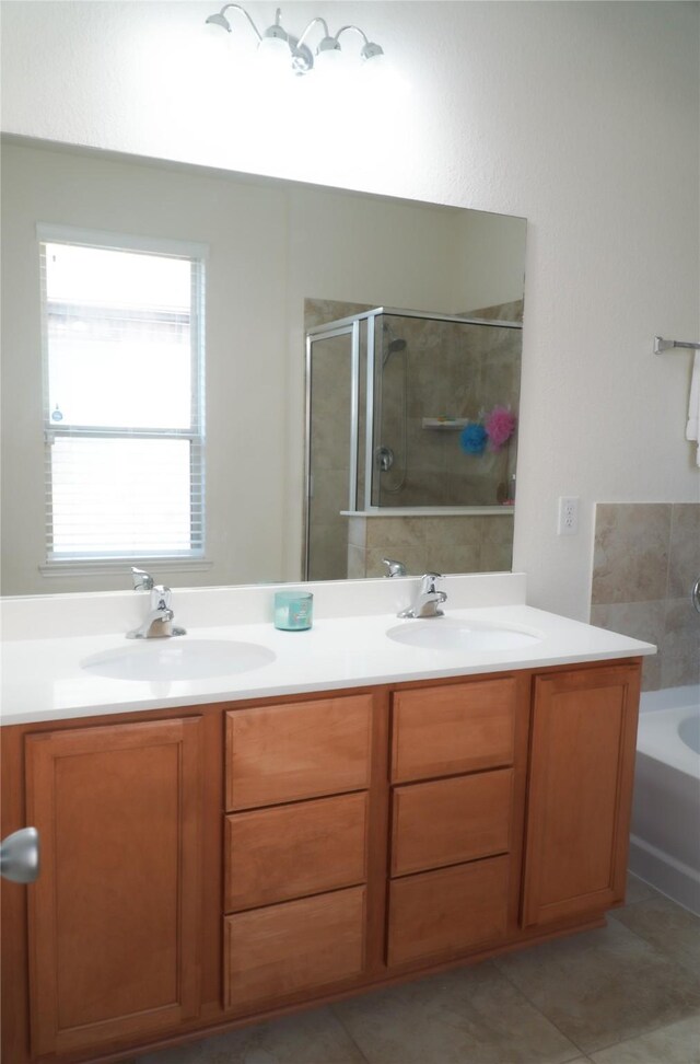 full bathroom with a shower with door, double vanity, a bath, and a sink