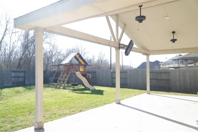 view of patio with a playground and a fenced backyard