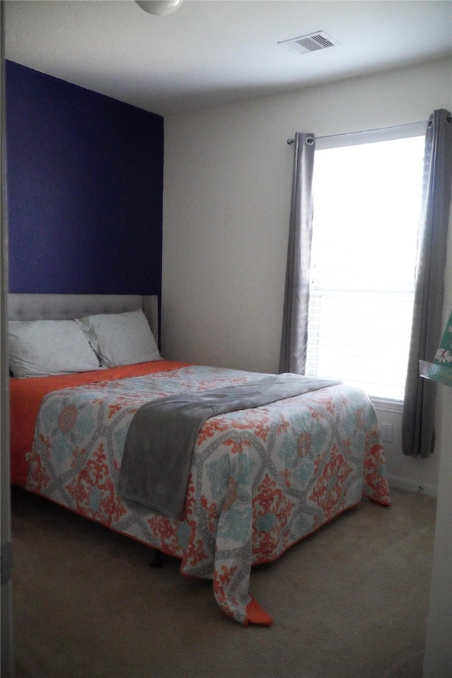 bedroom with visible vents and carpet floors