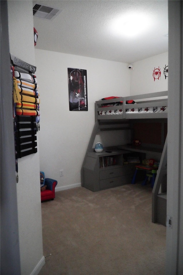 carpeted bedroom with visible vents and baseboards