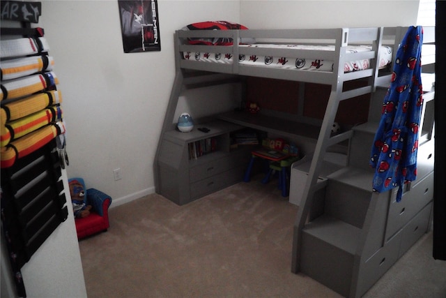 carpeted bedroom featuring baseboards