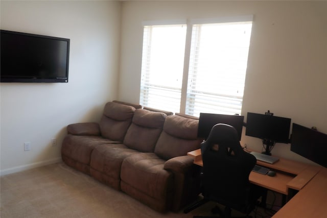 living room featuring light colored carpet and baseboards