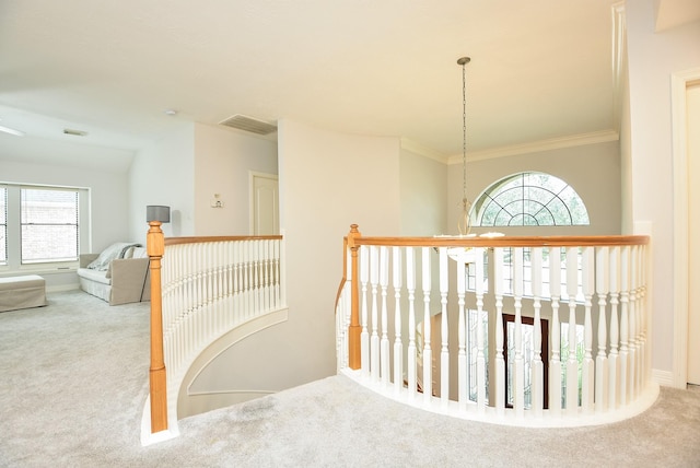 hallway with vaulted ceiling, carpet, visible vents, and ornamental molding