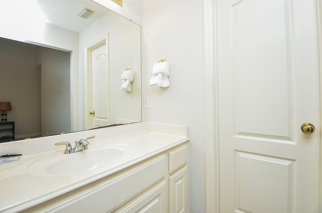 bathroom with vanity and visible vents