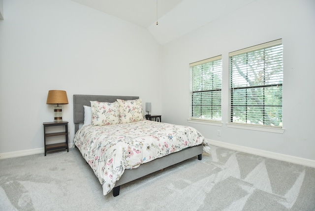 bedroom featuring baseboards, carpet floors, and vaulted ceiling