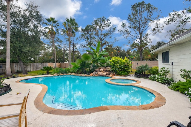 view of pool with a fenced in pool, an in ground hot tub, and a fenced backyard