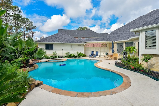 view of swimming pool with a patio area and a pool with connected hot tub