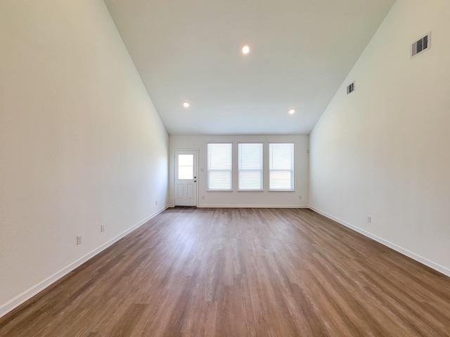 spare room with recessed lighting, visible vents, baseboards, and wood finished floors