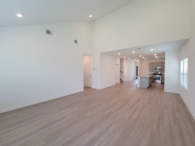 unfurnished living room featuring recessed lighting, visible vents, baseboards, and light wood-style floors