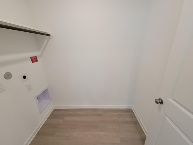 laundry room featuring laundry area, baseboards, light wood-type flooring, and electric dryer hookup