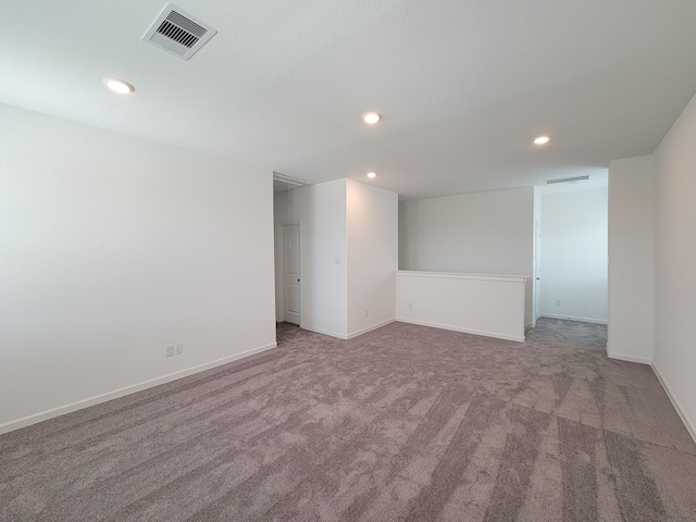 carpeted spare room with recessed lighting, visible vents, and baseboards