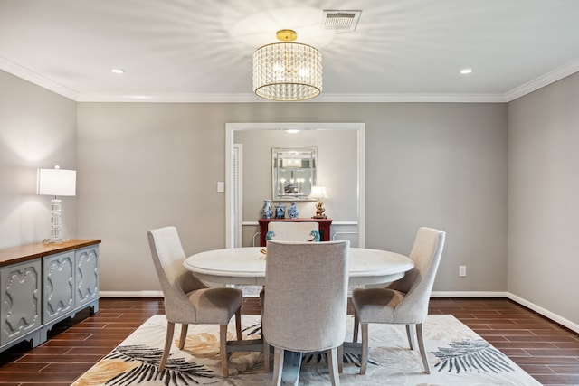 dining room with baseboards, crown molding, and wood finish floors