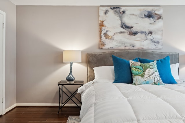 bedroom with baseboards and wood tiled floor