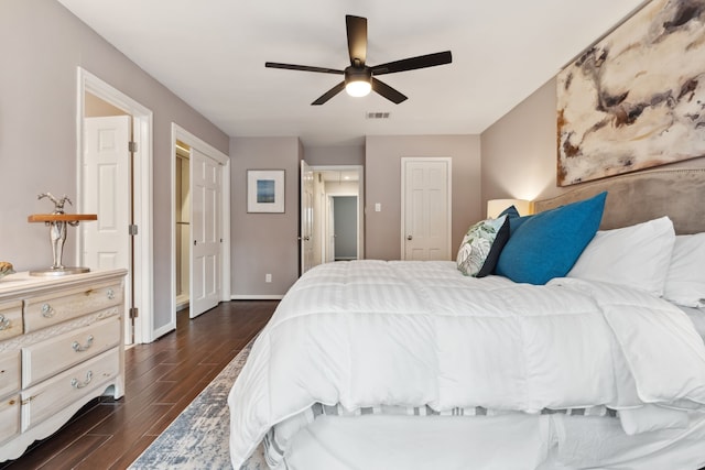 bedroom featuring visible vents, baseboards, a ceiling fan, and dark wood-style flooring