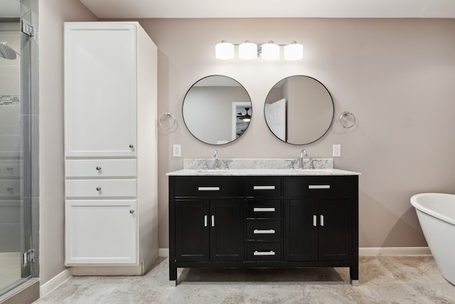 bathroom with a soaking tub, a sink, a shower stall, and double vanity