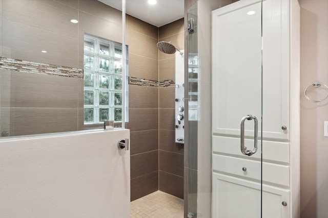 bathroom with plenty of natural light and a shower stall